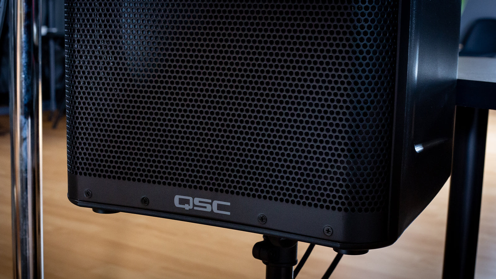 A QSC speaker on a stand in a studio