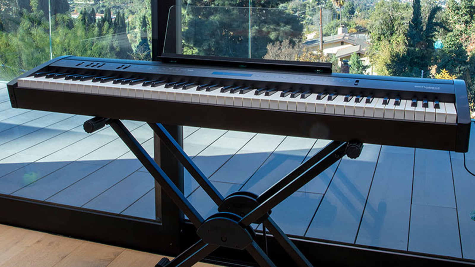 A Roland FP-60X on a stand in an apartment