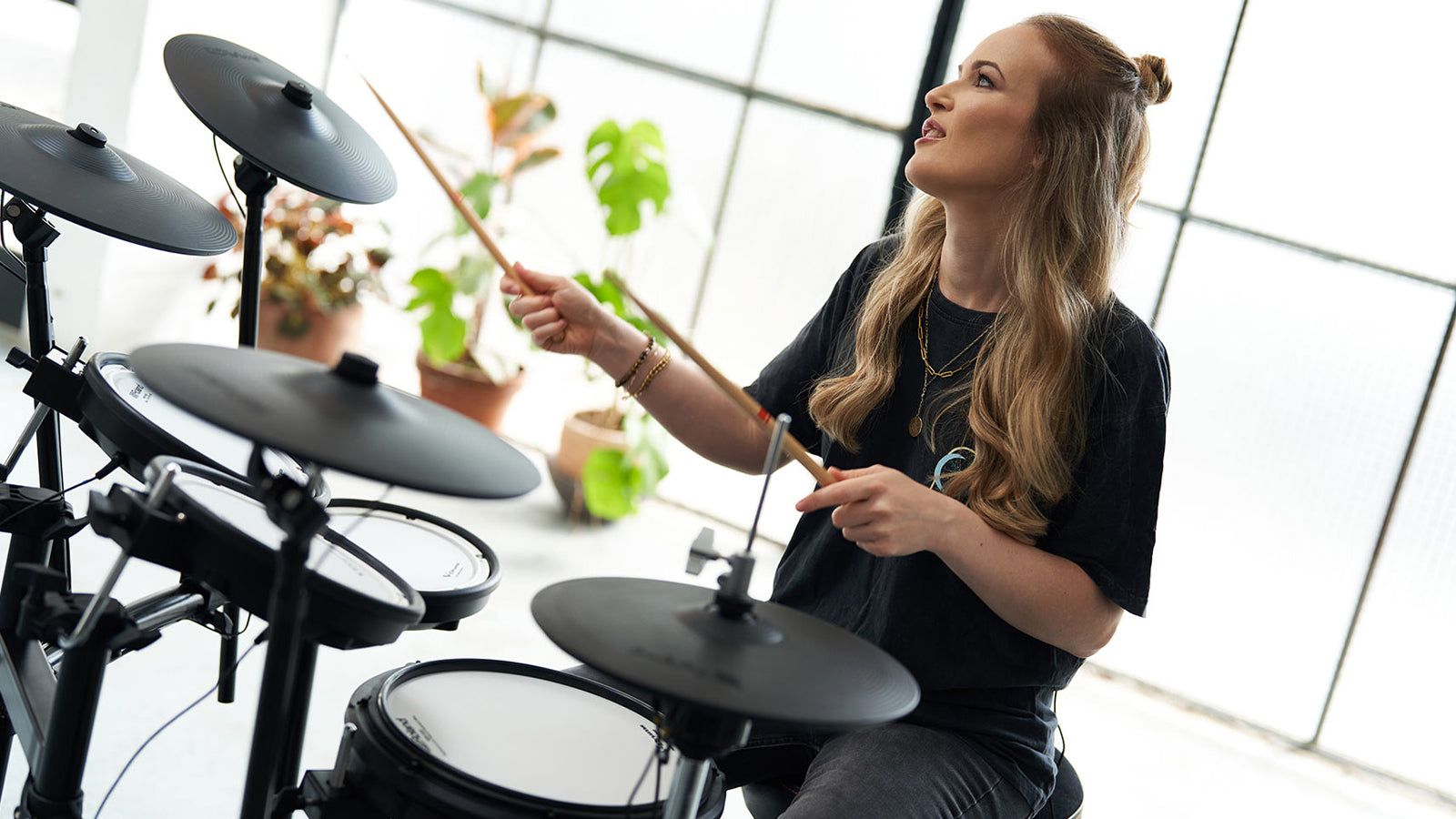 A young lady playing a Roland TD-17KVX2