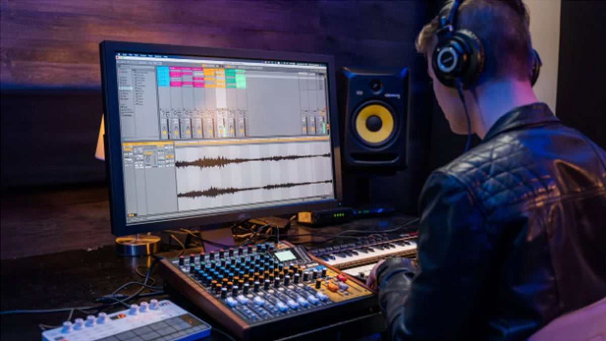 A young man using a TASCAM Model 12 in a studio setting