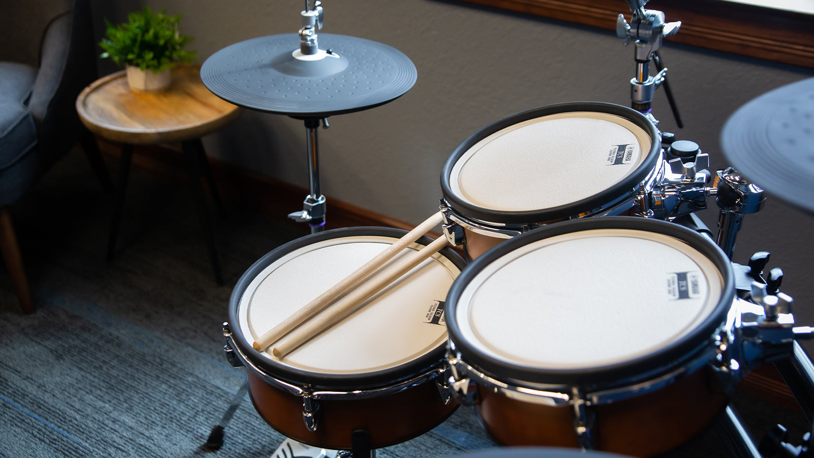 A Yamaha DTX drum set in a stylish living room