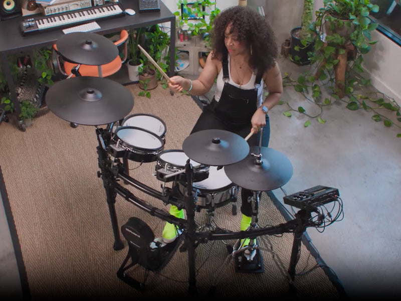 Woman playing a Roland TD-27KV2