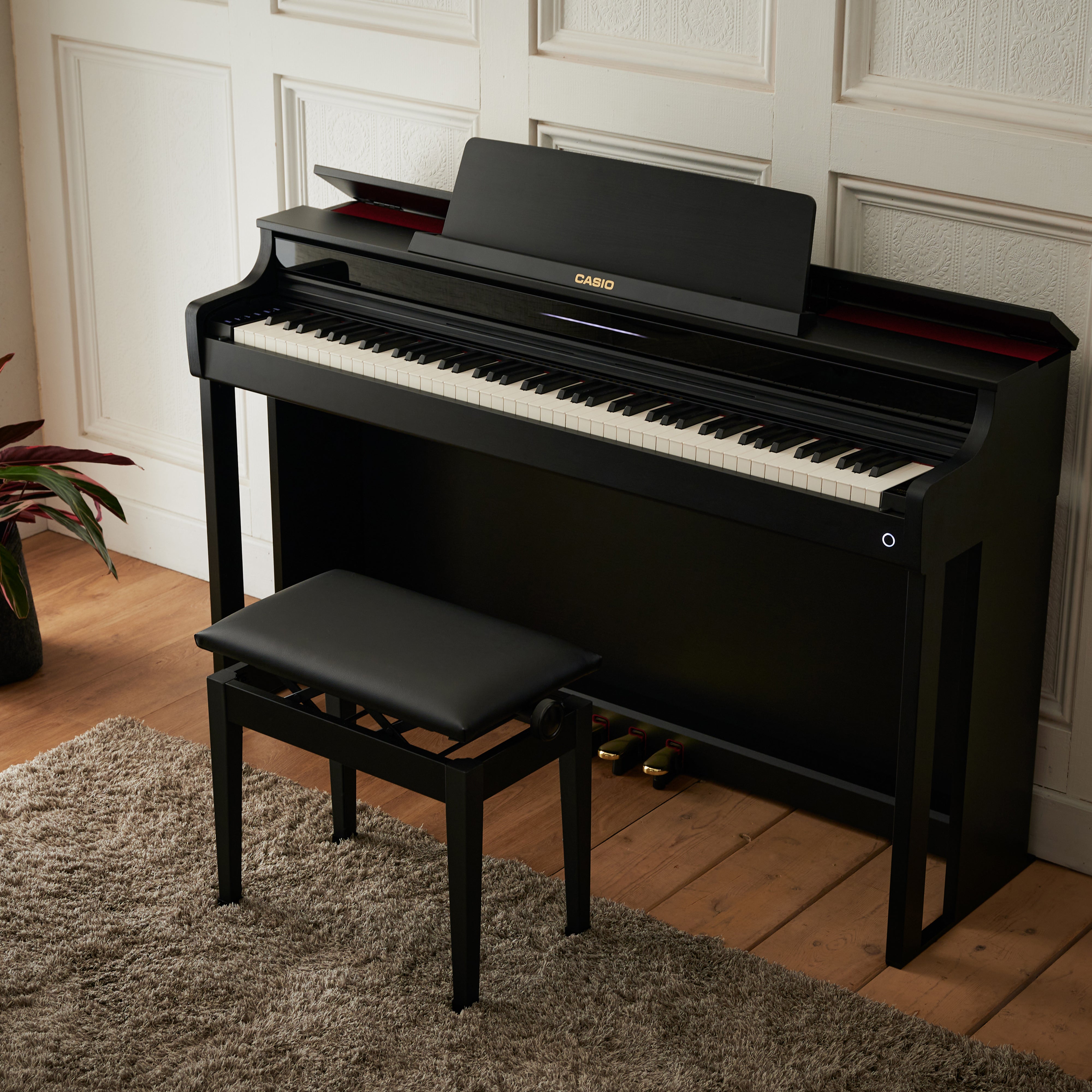 Casio Celviano AP-550 Digital Piano - Black - facing left in a stylish living room
