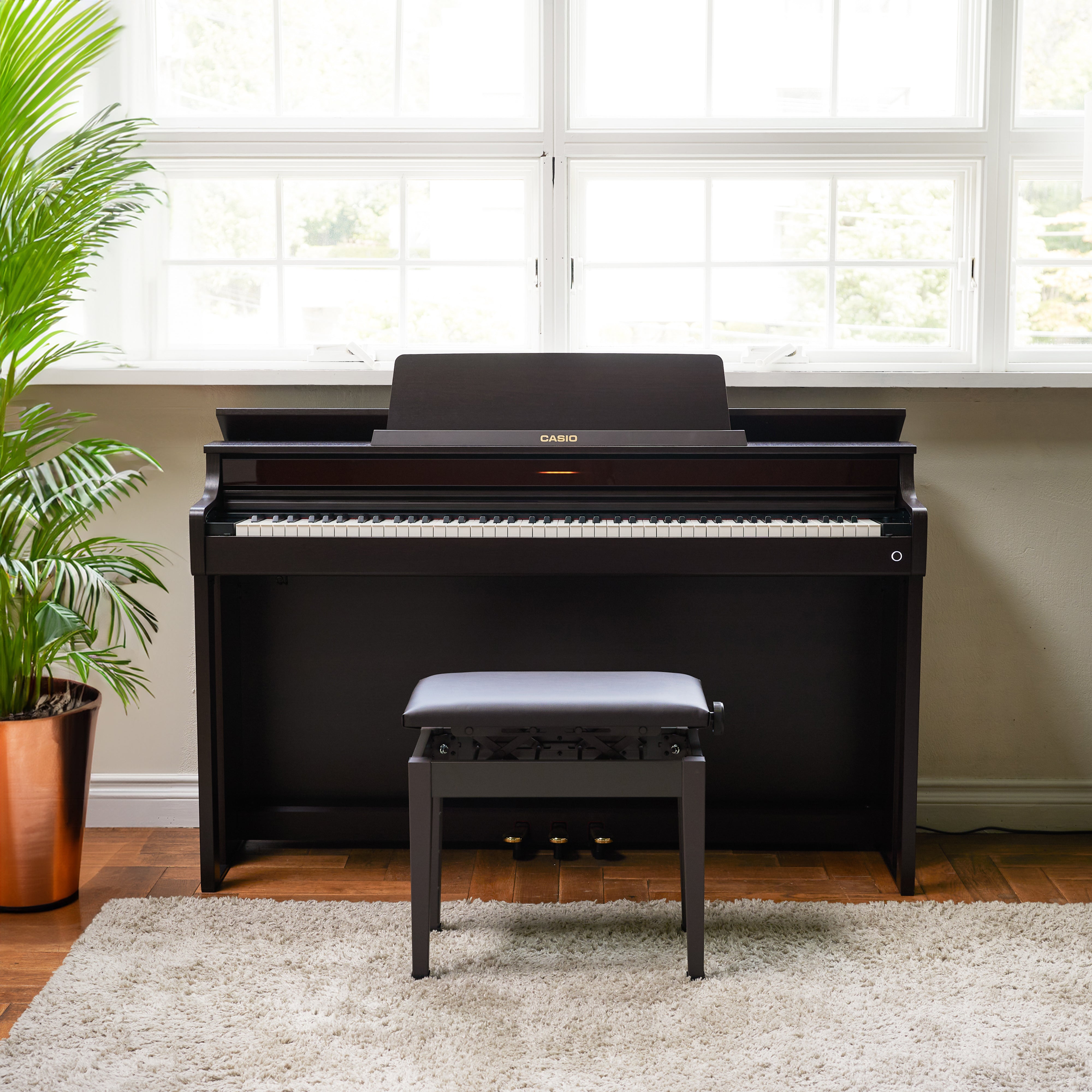 Casio Celviano AP-550 Digital Piano - Brown - front view in a stylish living room
