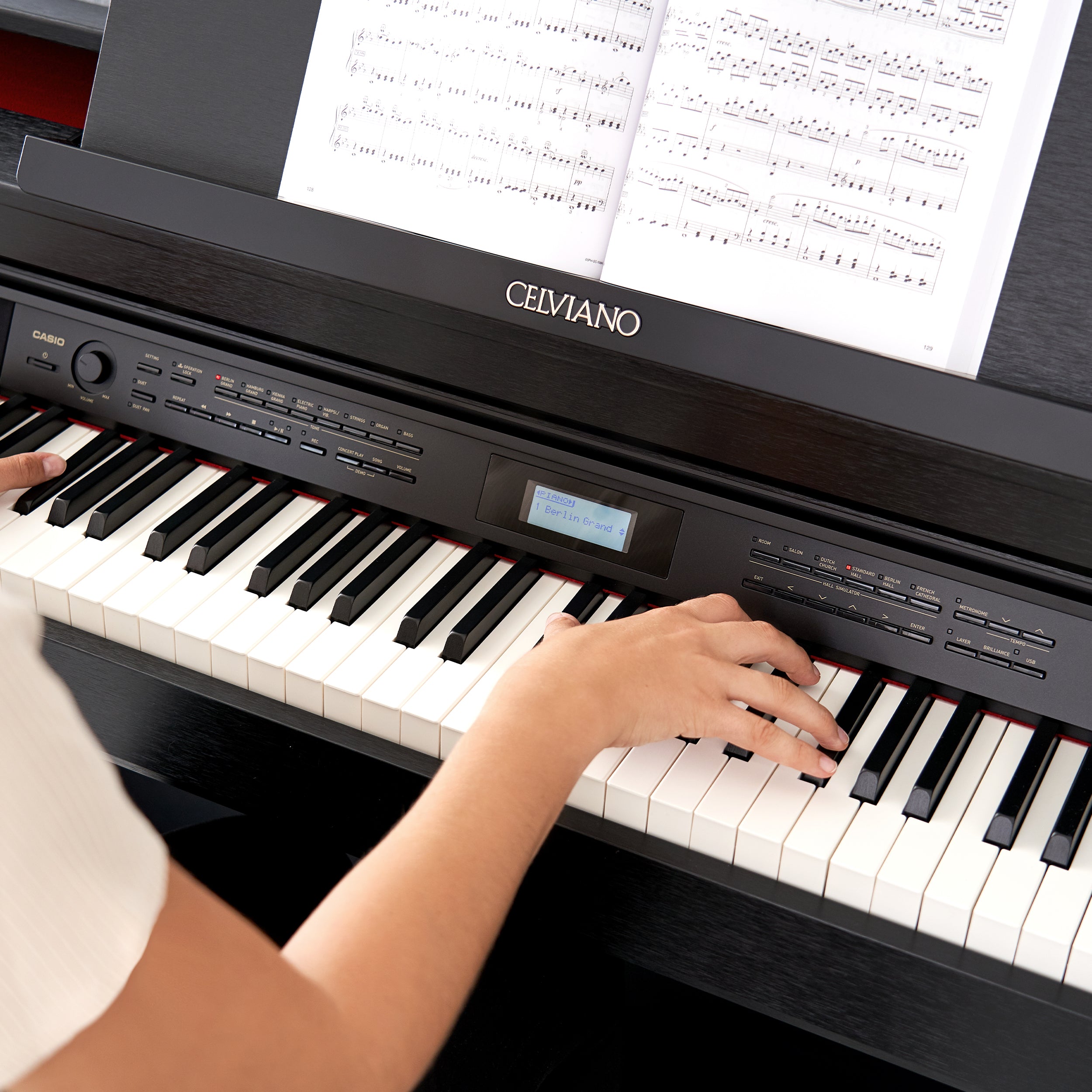 A close up view of a woman playing a Casio Celviano AP-710 Digital Piano