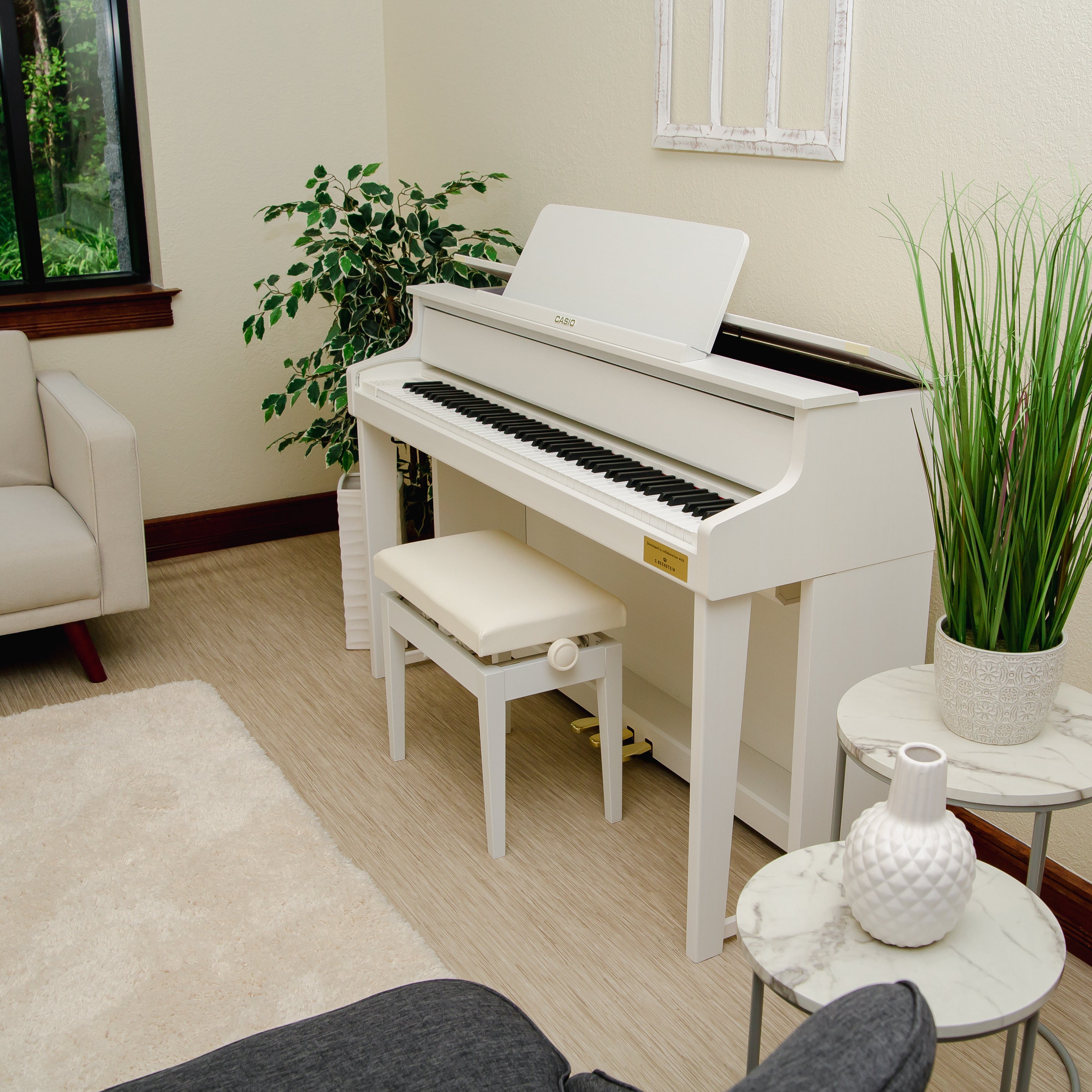 Casio Celviano Grand Hybrid GP-310 Digital Piano - Natural White Wood - Left angle in a stylish living room