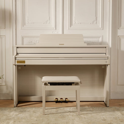 Casio Celviano AP-750 Digital Piano - Grey Beige with a bench in a room with white paneled walls.