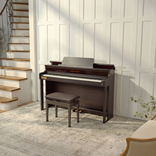 Casio Celviano AP-750 Digital Piano - Rosewood with bench in a room with wooden stairs and white walls