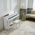 Casio Celviano AP-750 Digital Piano - White in a room with a bench and decorative elements