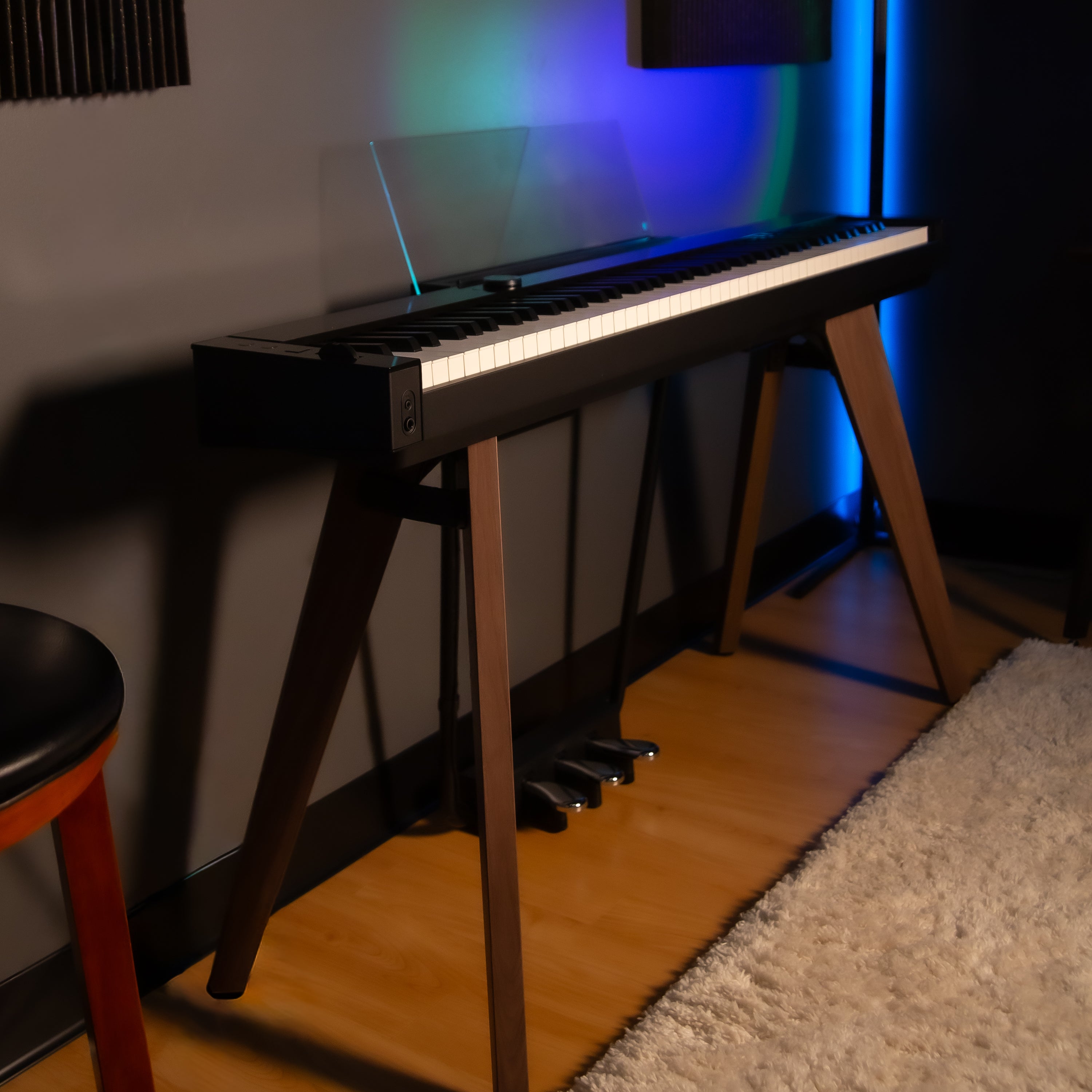 Casio PX-S7000 Digital Piano - Black - side view in a home studio