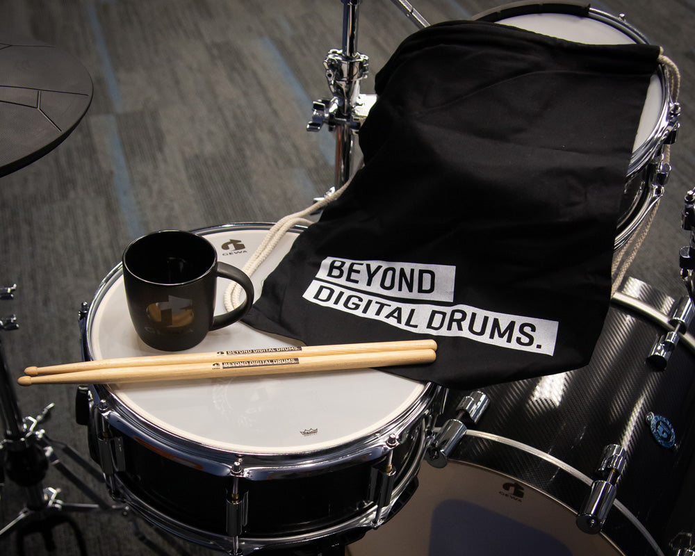 GEWA logo drumsticks, coffee mug, and sport bag on GEWA kit