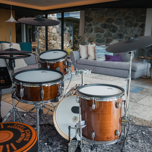 Gretsch Catalina EVO Walnut Glaze electronic drum kit from the drummer's seat in a modern living room