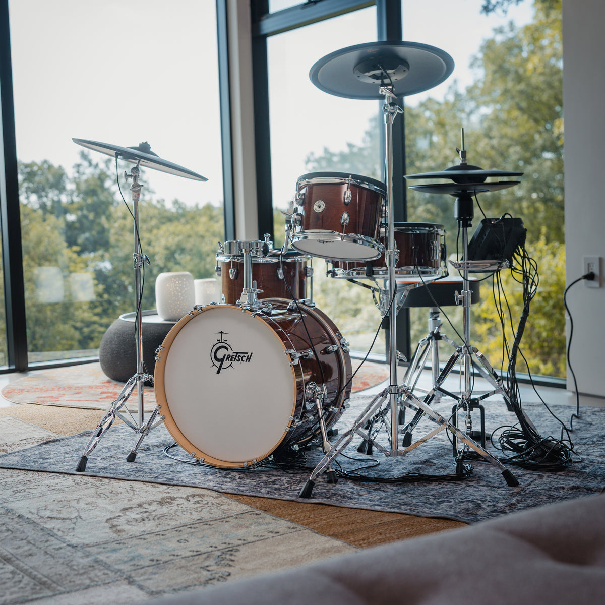 Gretsch Catalina EVO Walnut Glaze electronic drum kit in a sunlit corner with window views