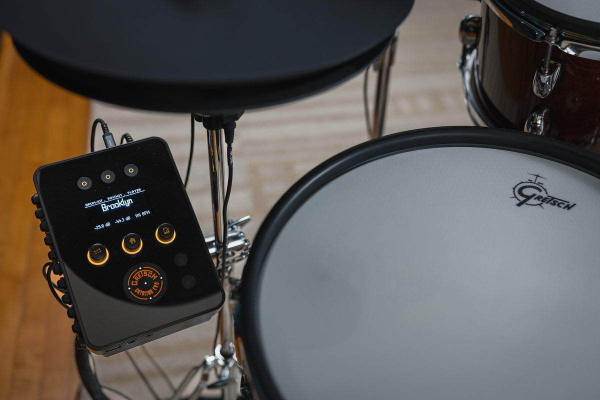 Overhead view of Gretsch Catalina EVO drum module with OLED display beside snare pad