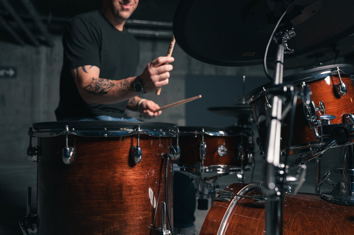 Drummer playing Gretsch Catalina EVO Walnut Glaze kit, floor tom in foreground