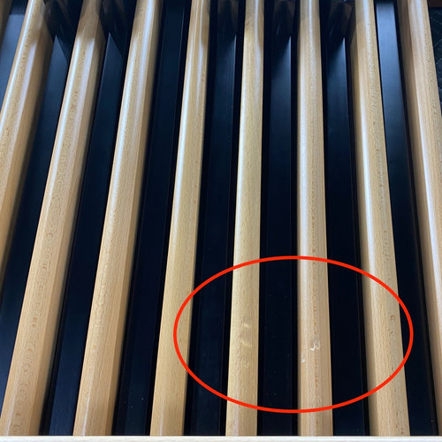 Cosmetic blemish on two of the wood pedals