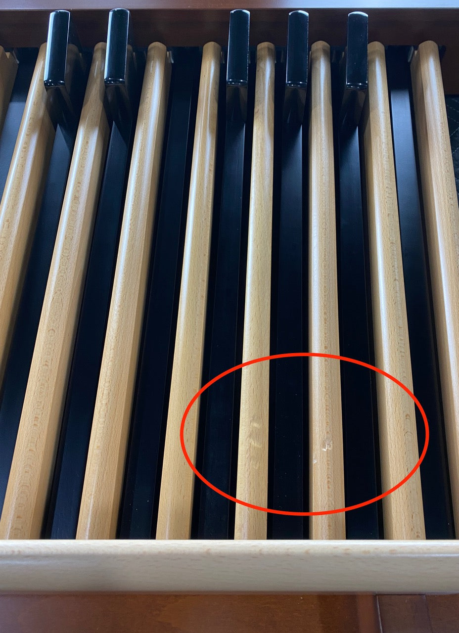 Cosmetic blemish on two of the wood pedals