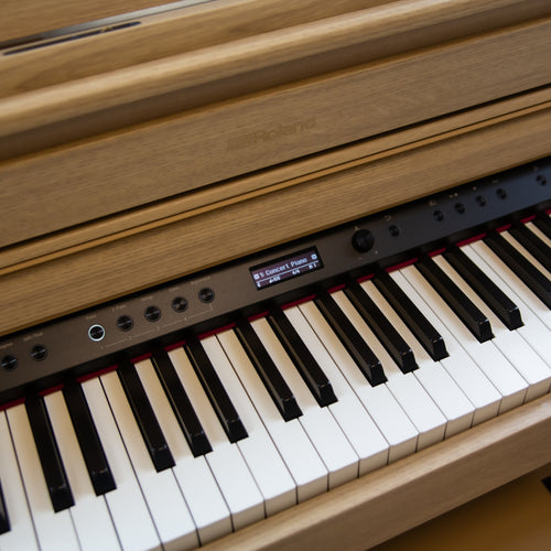 Close-up of a Roland HP704 Digital Piano - Light Oak