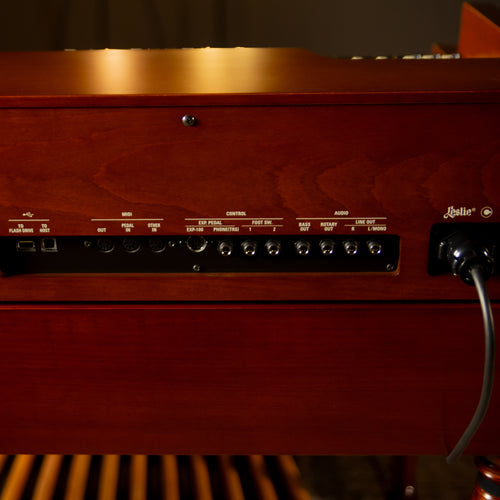 Close-up of the rear panel of a Hammond XK-7D Classic Ultimate Dual-Manual Tonewheel Organ System, showing control knobs, jacks, and a Leslie speaker plugged in.