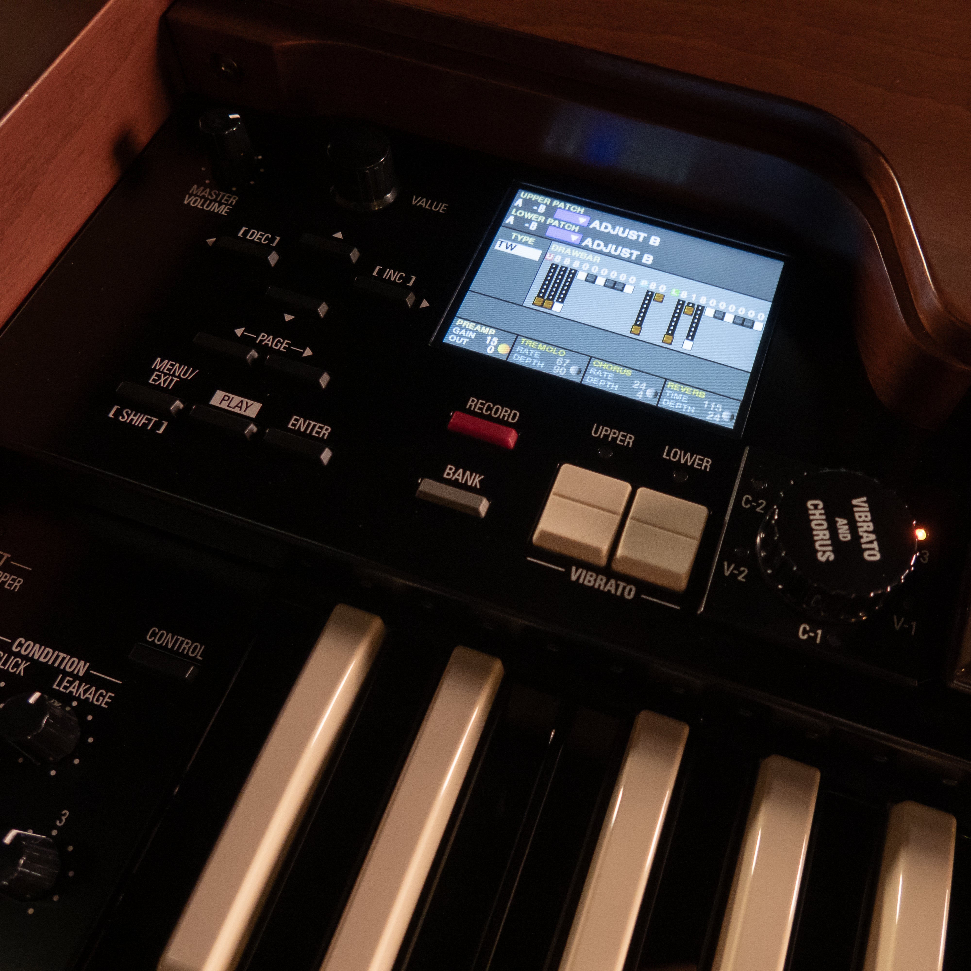 Close-up of a Hammond XK-7D Classic Ultimate Dual-Manual Tonewheel Organ System showing the control panel with a display screen, rotary knobs, and buttons