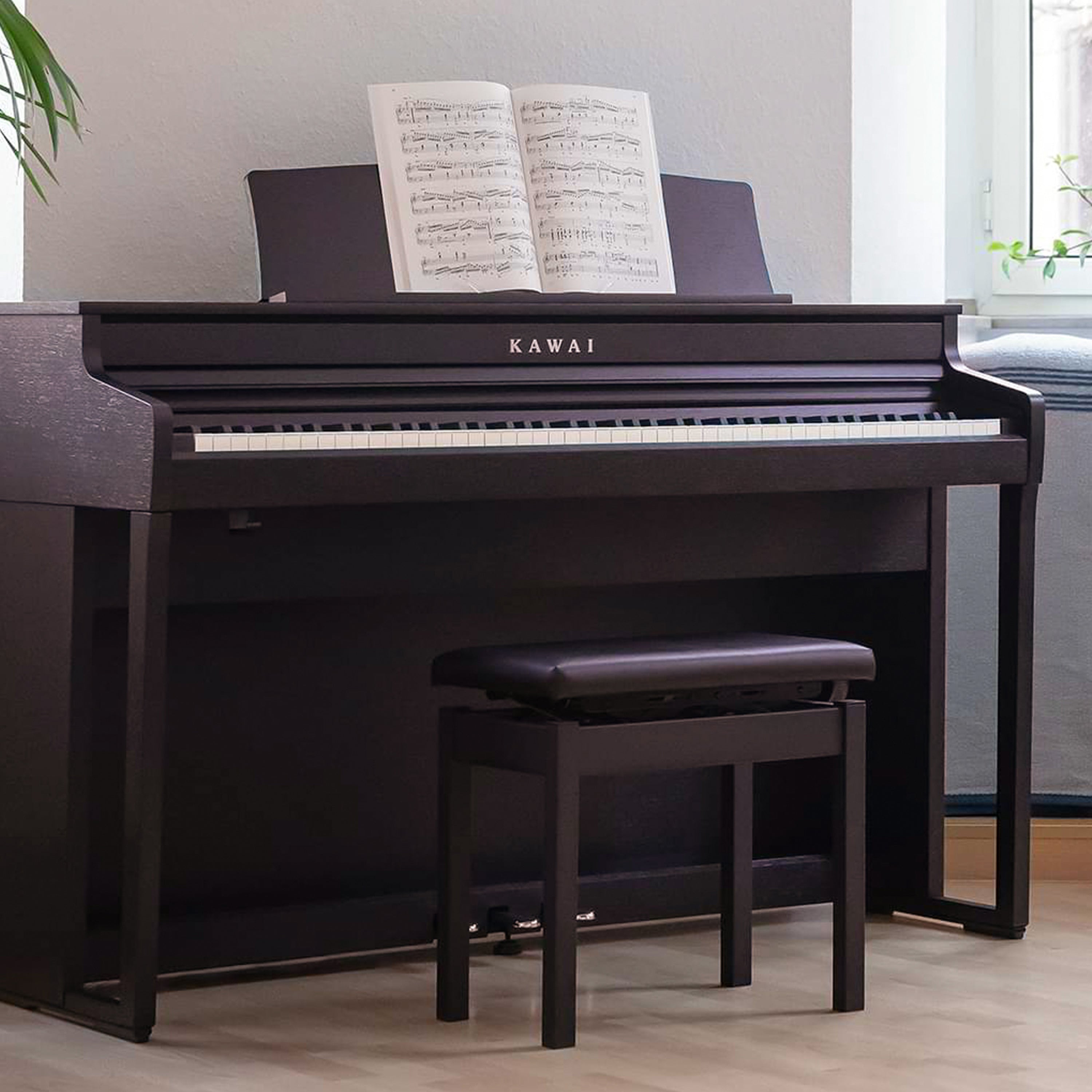 A right angle view of a rosewood Kawai CA401 Concert Artist digital piano in a stylish living room