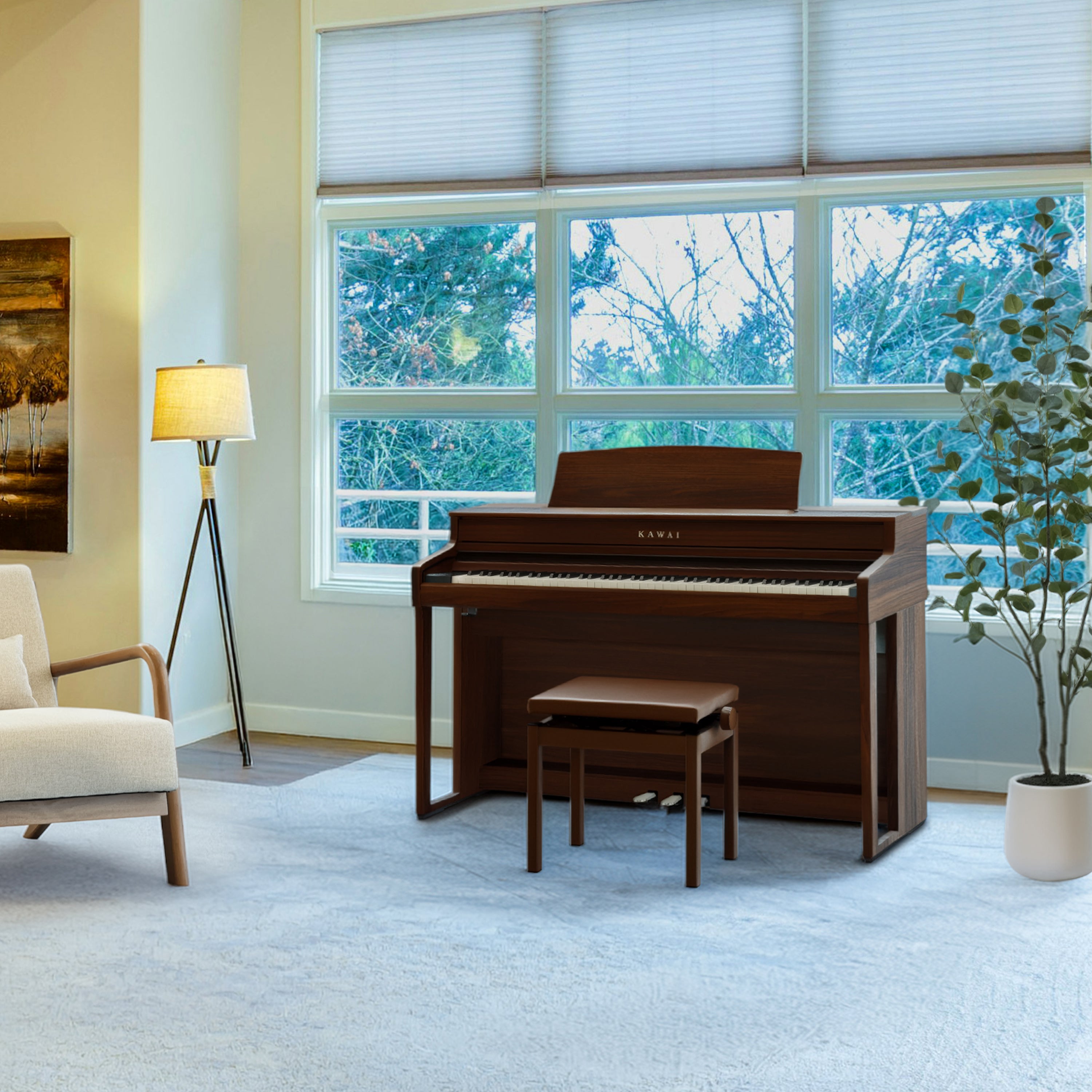 Kawai CA501 Concert Artist Digital Piano - Mocha Walnut in a warm brown wood finish, shown in a bright, modern living room setting with a matching bench, a floor lamp, and large windows looking out to trees.