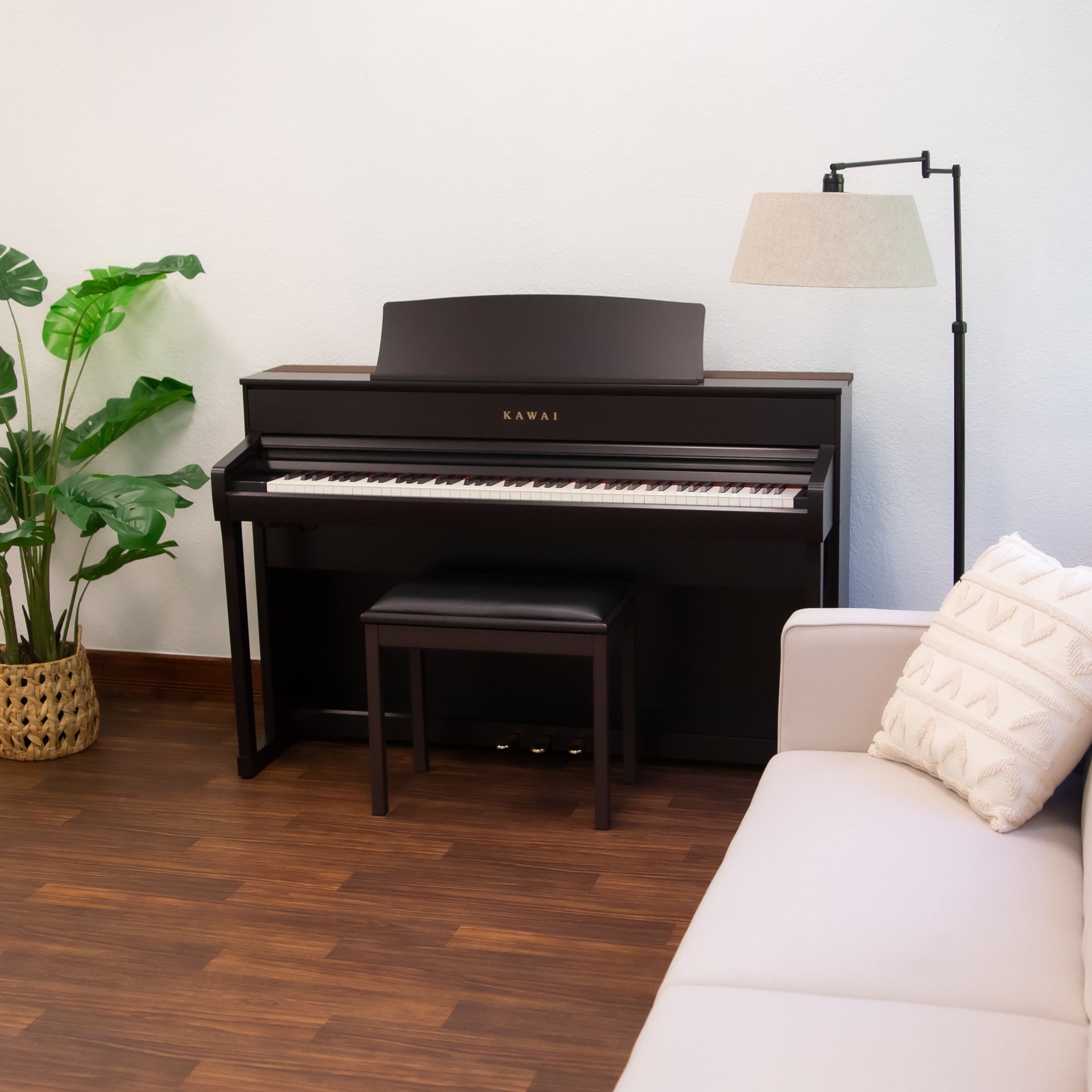 Kawai CA701 Digital Piano - Rosewood - left facing in a stylish living room