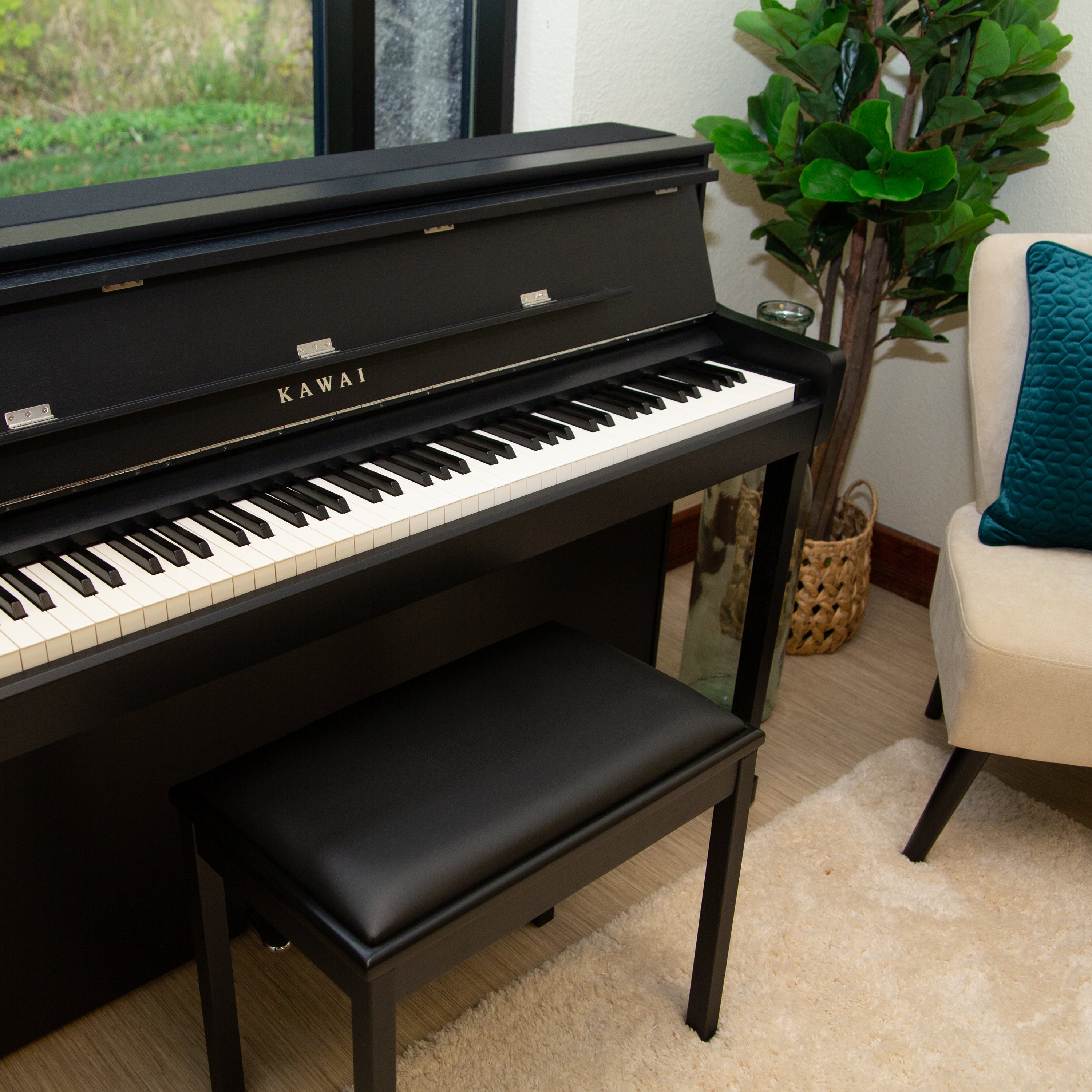 Kawai CA901 Digital Piano - Satin Black - facing right in a stylish living room