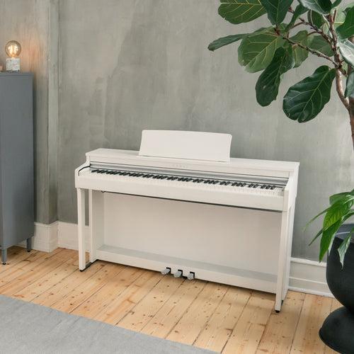 Kawai CN201 Digital Piano - Satin White - Left angle in a stylish living room