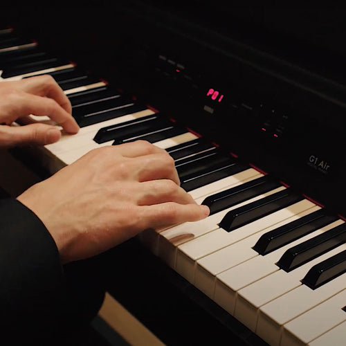 Hands playing a Korg G1B Air Digital Piano
