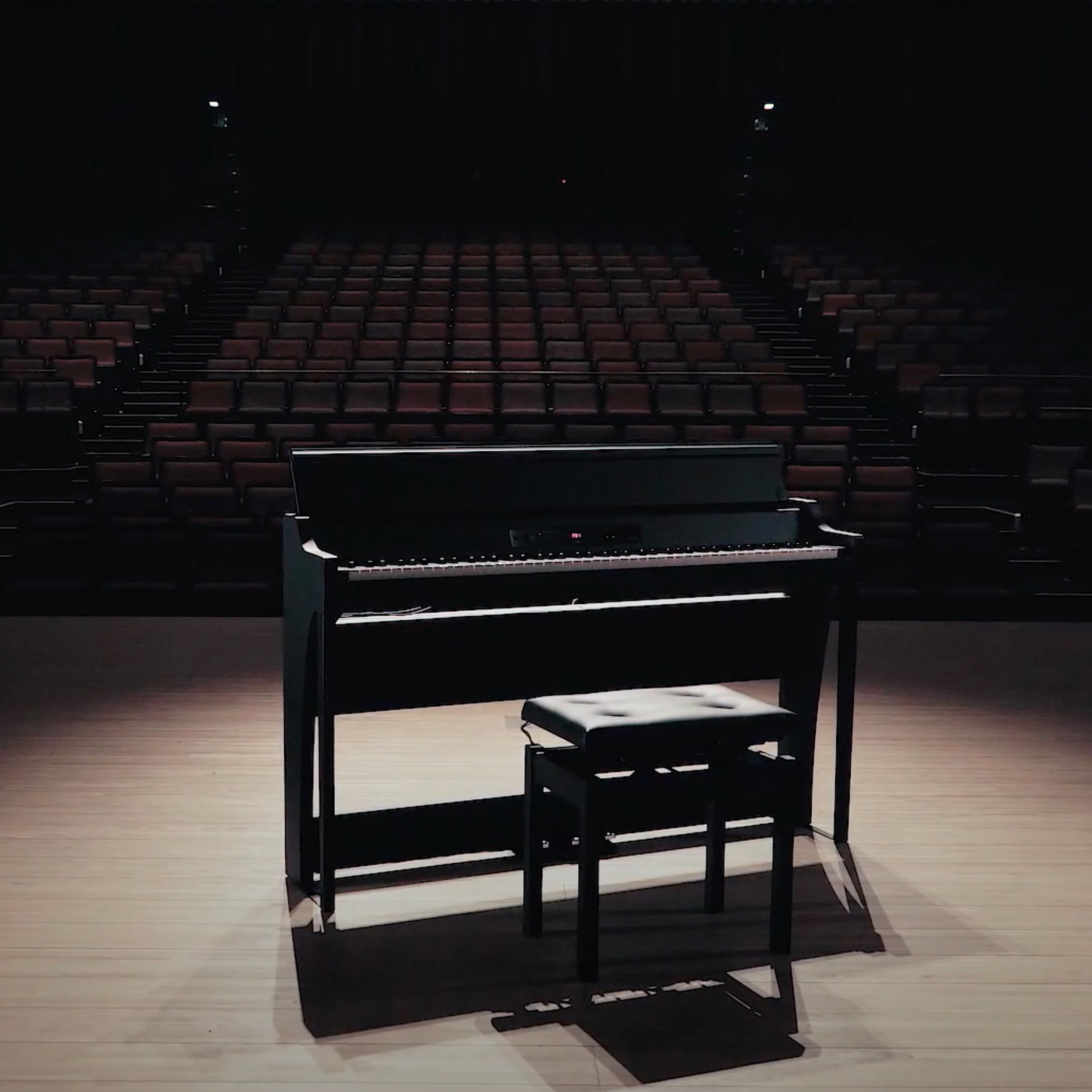 Korg G1B Air Digital Piano - Black - on a dim lit stage