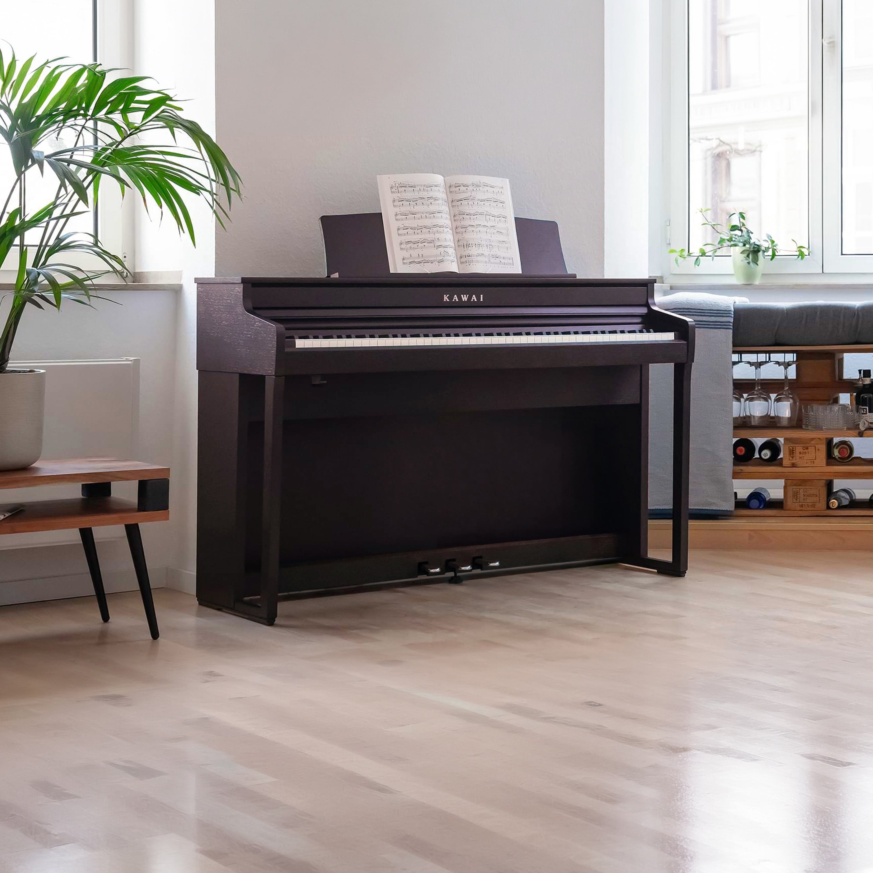 A left angle view of a rosewood Kawai CA401 Concert Artist digital piano in a stylish living room