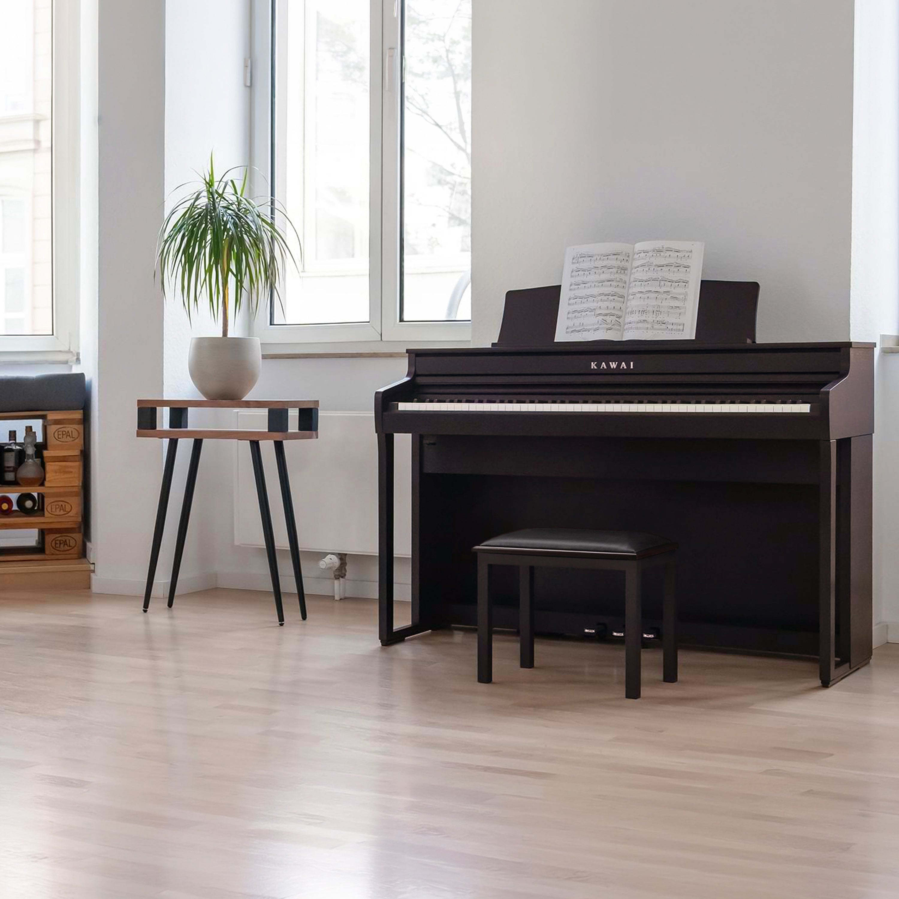 A right angle view of a rosewood Kawai CA401 Concert Artist digital piano in a stylish living room