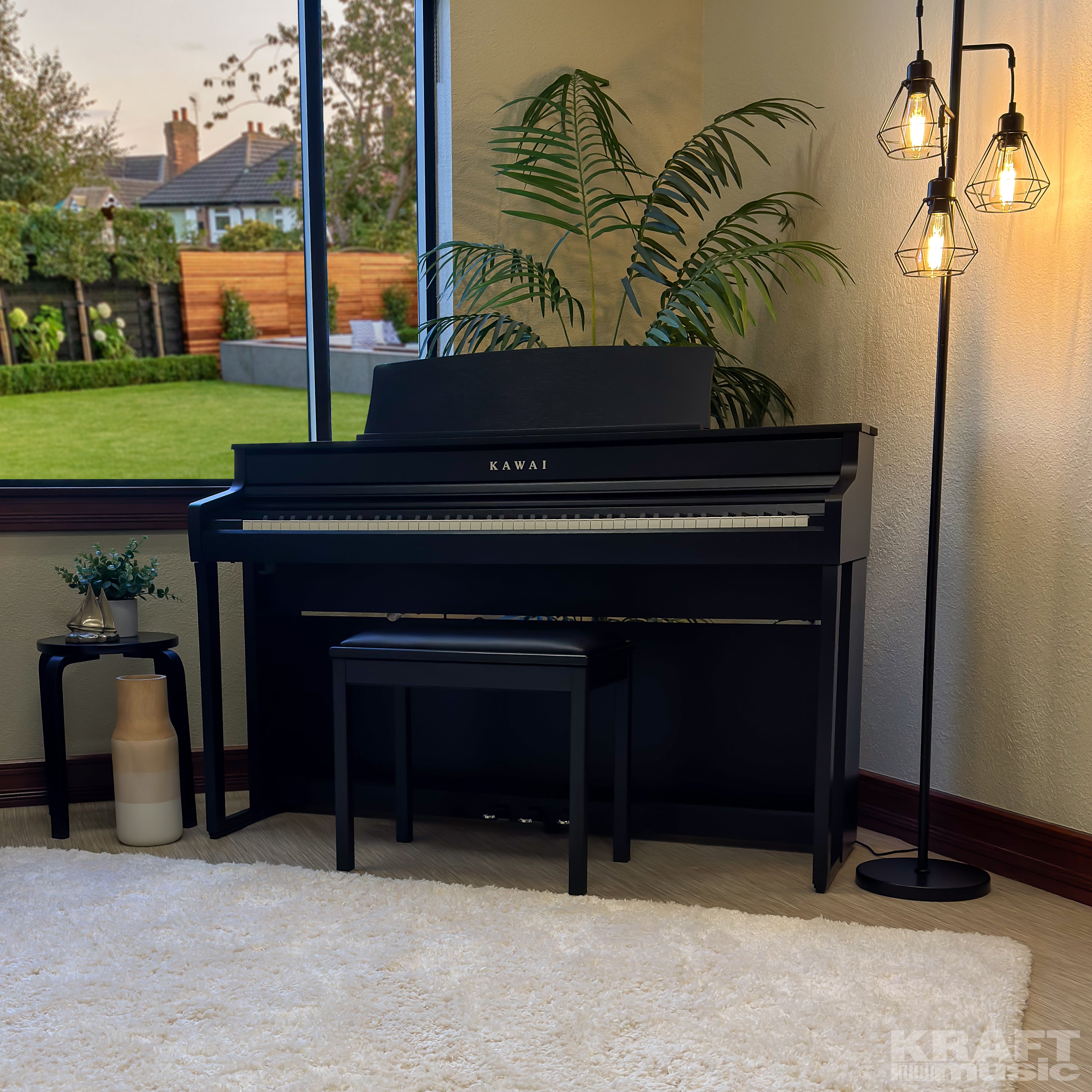 Kawai CA501 Concert Artist Digital Piano - Satin Black - in a stylish living room facing left