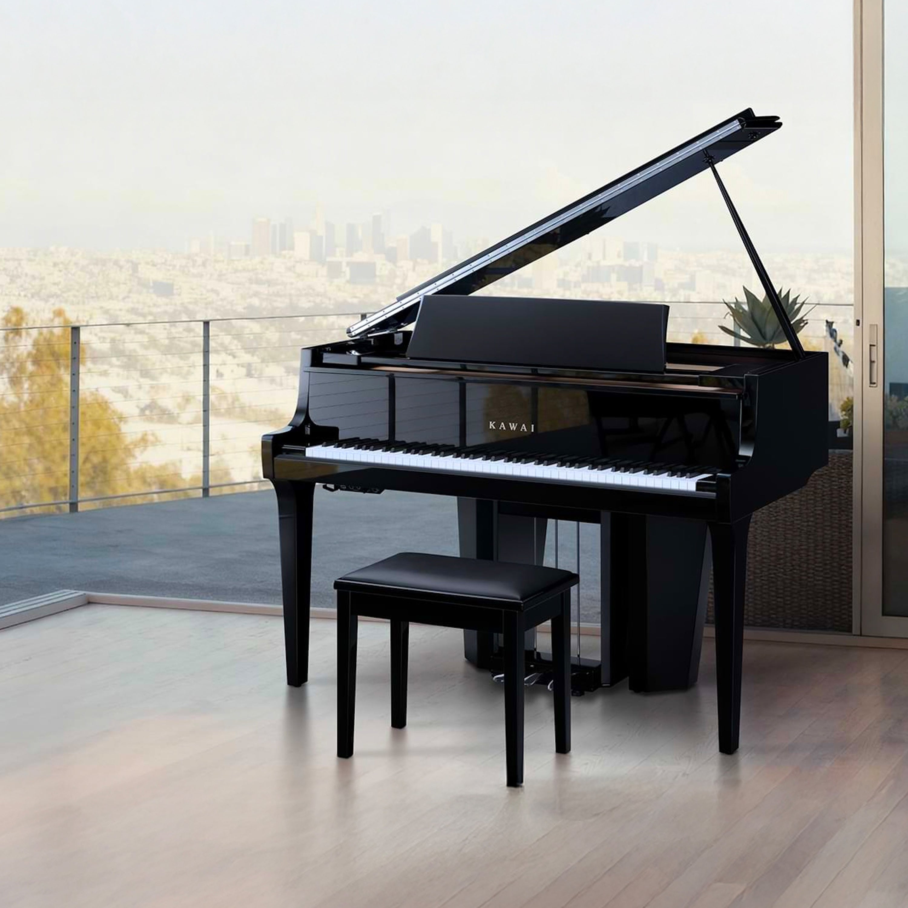 Kawai NOVUS NV12 Hybrid Grand Piano -  Ebony Polish with a bench on a wooden floor, large window in the background