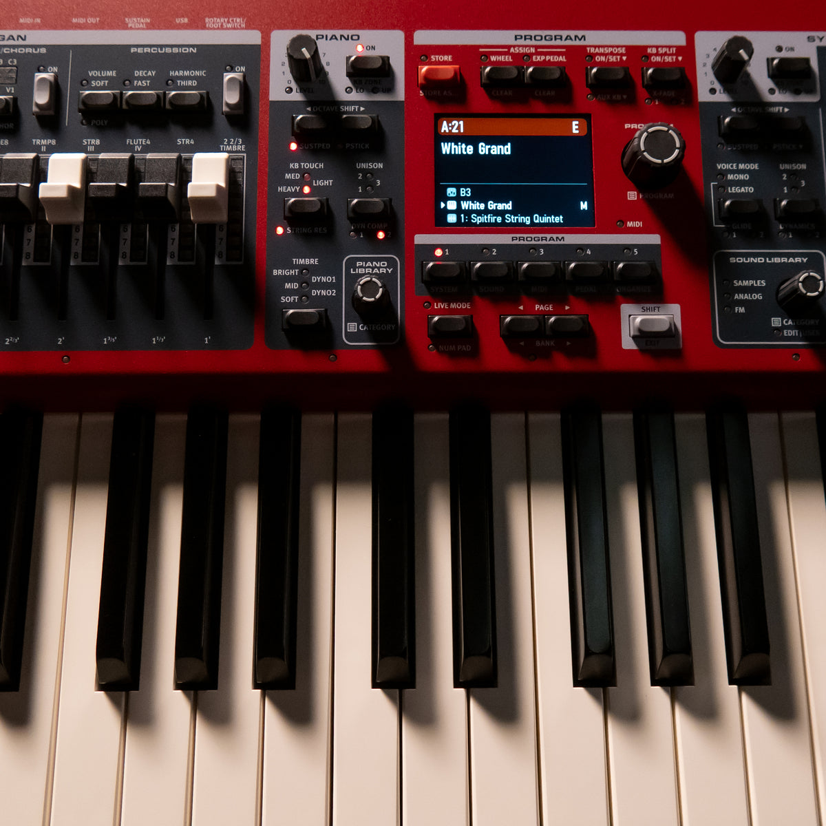 Close-up of a Nord Electro 7 with black and white keys, control knobs, and a small display screen.