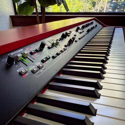 Nord Grand 2 on a desk with a window in the background