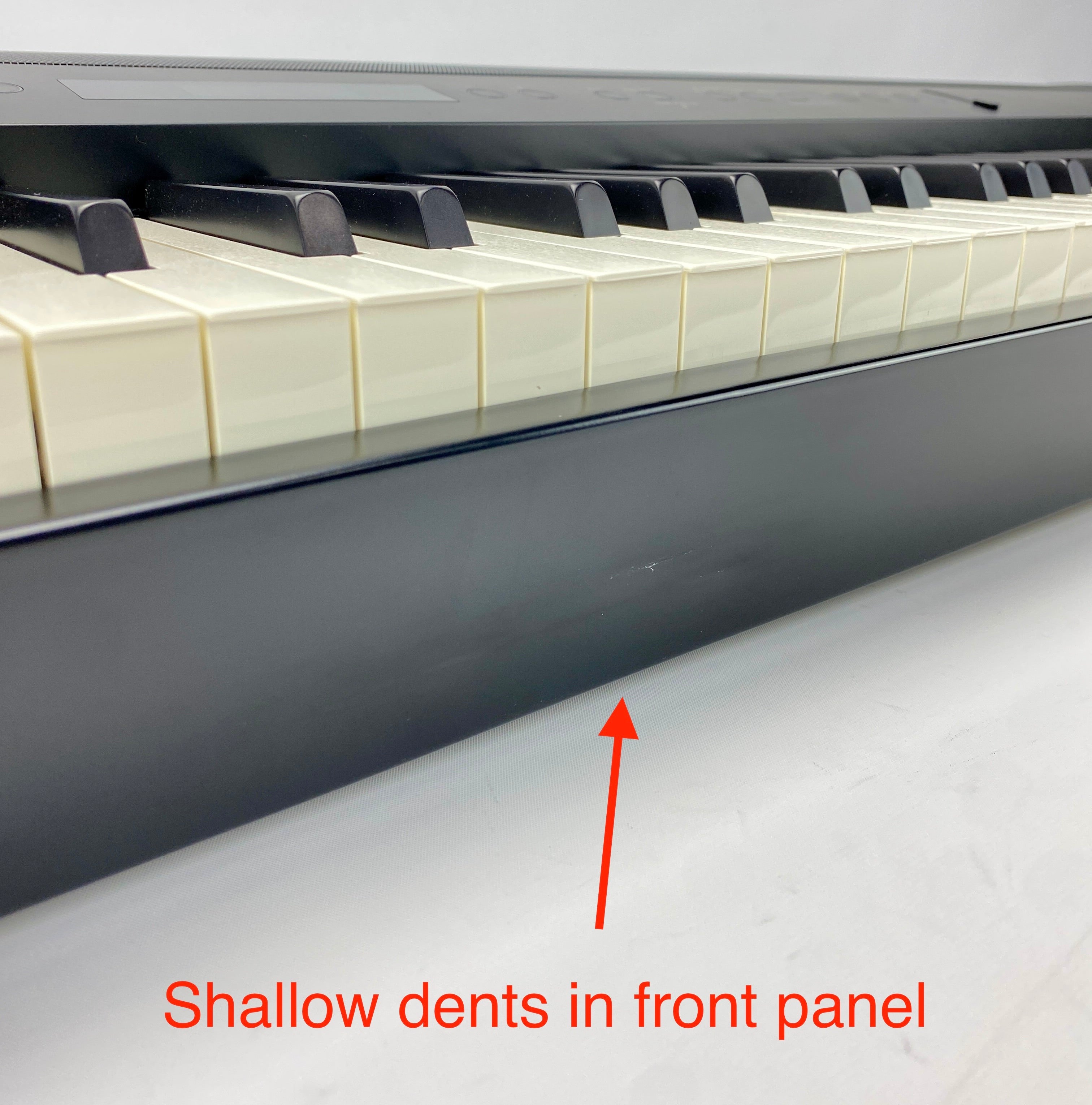 Shallow dents on the front panel of the instrument