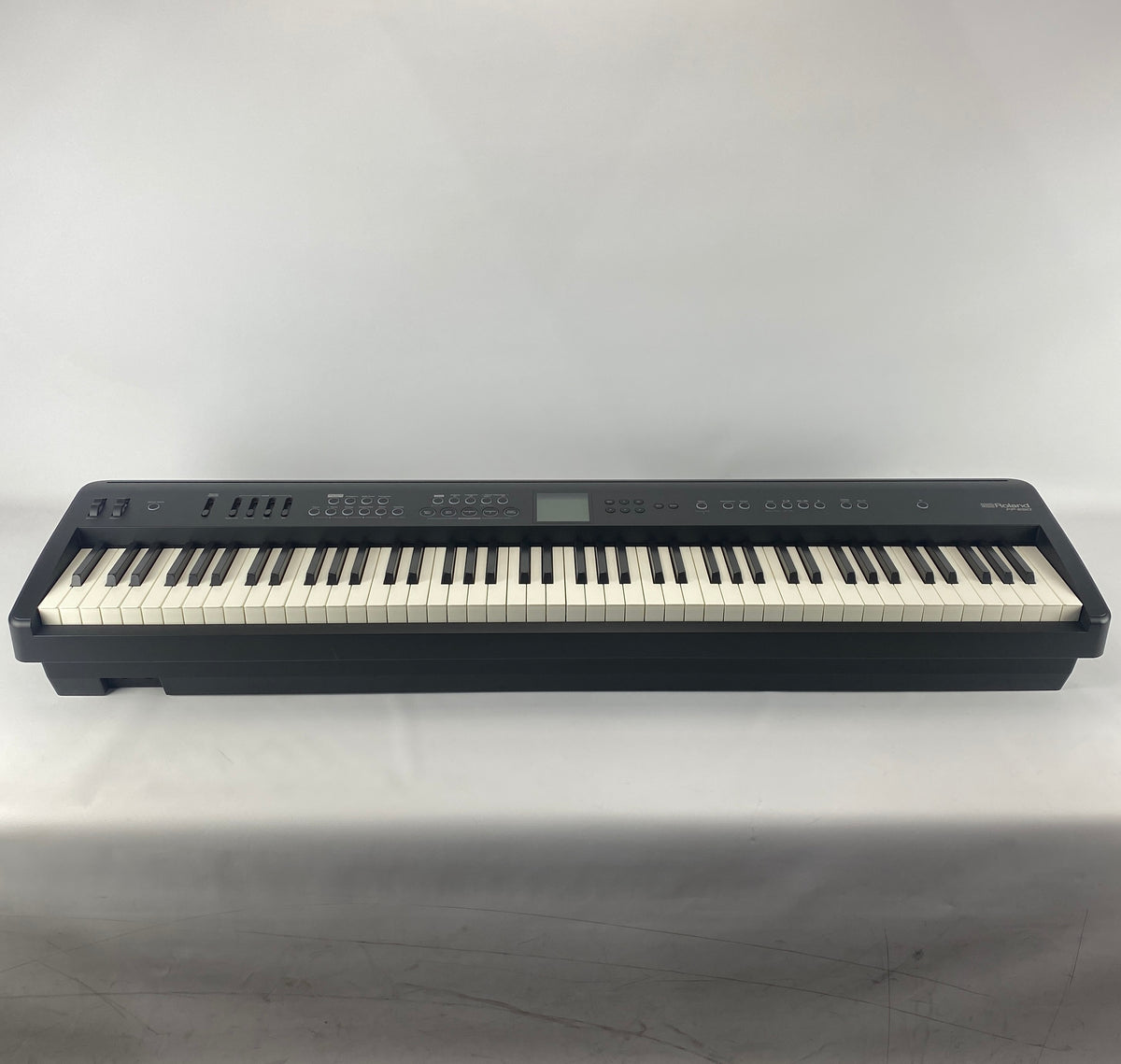 Roland FP-E50 88-key digital piano in black, full front view showing keyboard, control panel and display