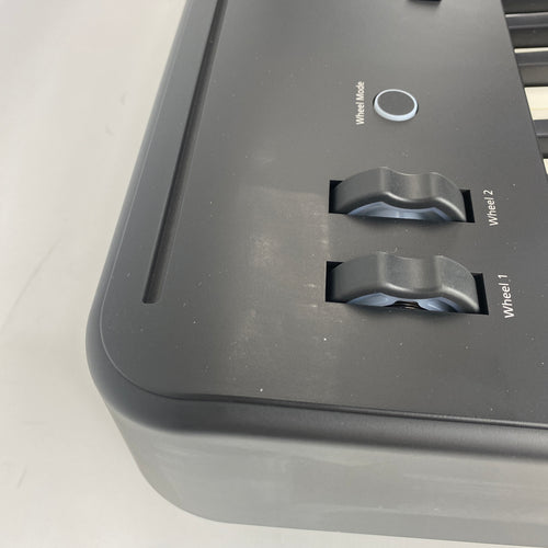 Left end of Roland FP-E50 showing pitch and mod wheels and Wheel Mode button, with scuffing on panel and side