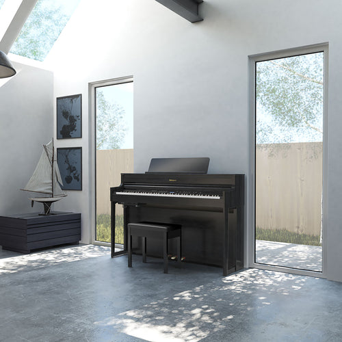 Roland HP704 Digital Piano - Charcoal Black - in a stylish living room