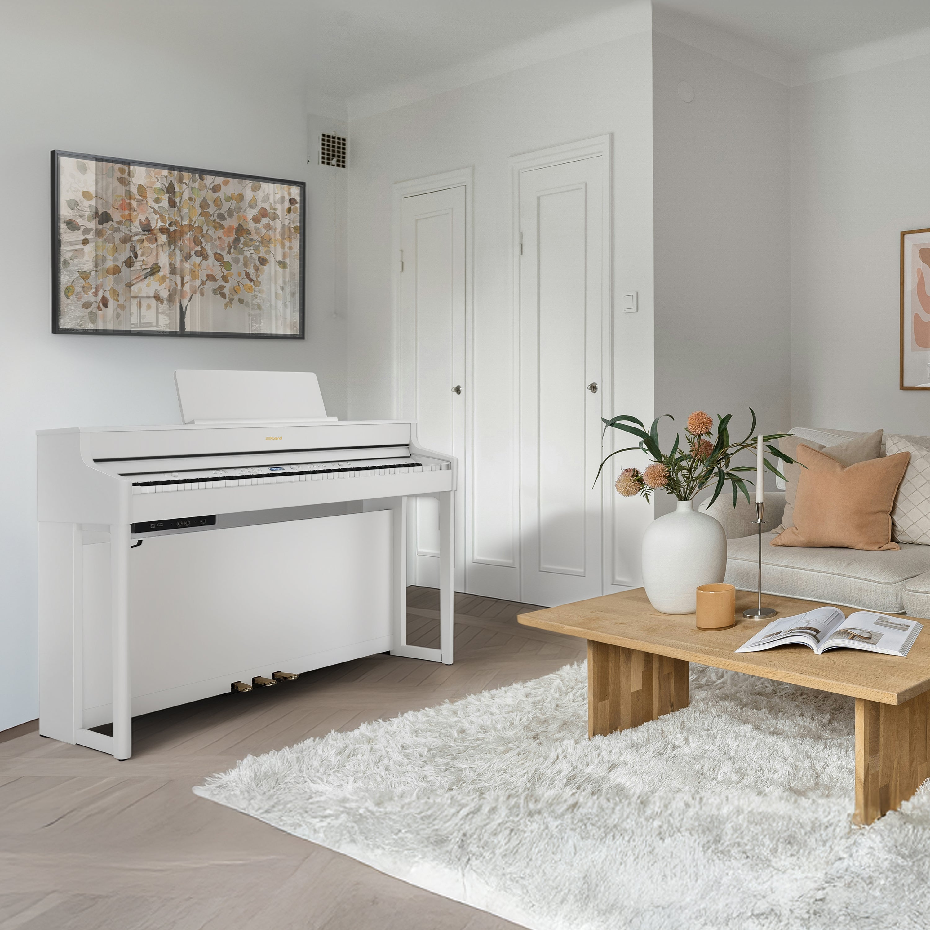 Roland HP702 Digital Piano - Satin White in a modern living room with a coffee table and decorative items.