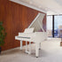 Roland GP-9 Digital Grand Piano - Polished White in a modern room with wooden wall and large window