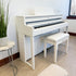 Roland HP704 Digital Piano - Satin White - in a stylish living room