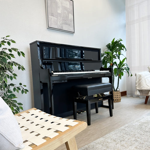 Roland LX708 Digital Piano - Polished Ebony - right facing in a stylish living room