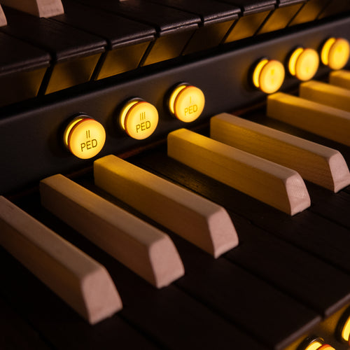 Close-up of a Viscount Cantorum Trio Plus Wood Keys 3 Manual Portable Organ with illuminated controls