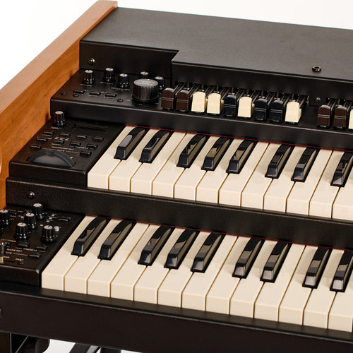 Front-left view of the Viscount Legend 261, showing the volume, keyclick, and rotary gain knobs and the Vibrato and Chorus control beside the drawbars and manuals