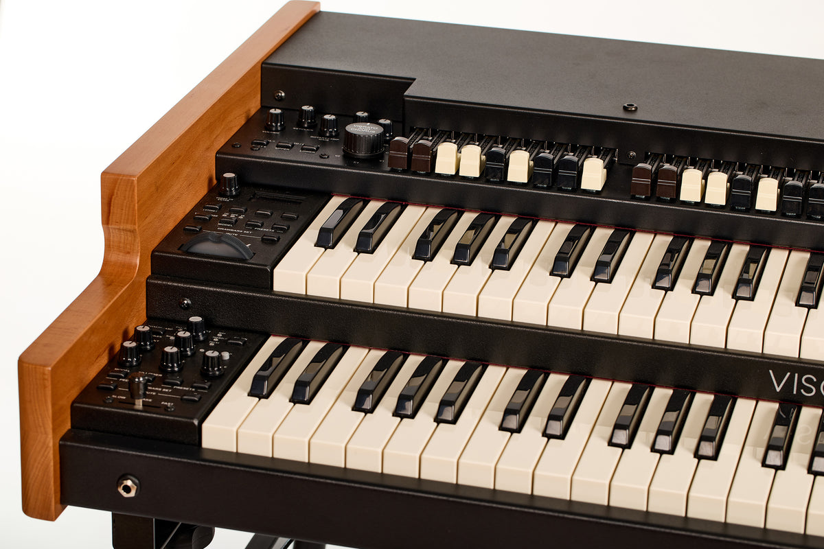 Front-left view of the Viscount Legend 261, showing the volume, keyclick, and rotary gain knobs and the Vibrato and Chorus control beside the drawbars and manuals