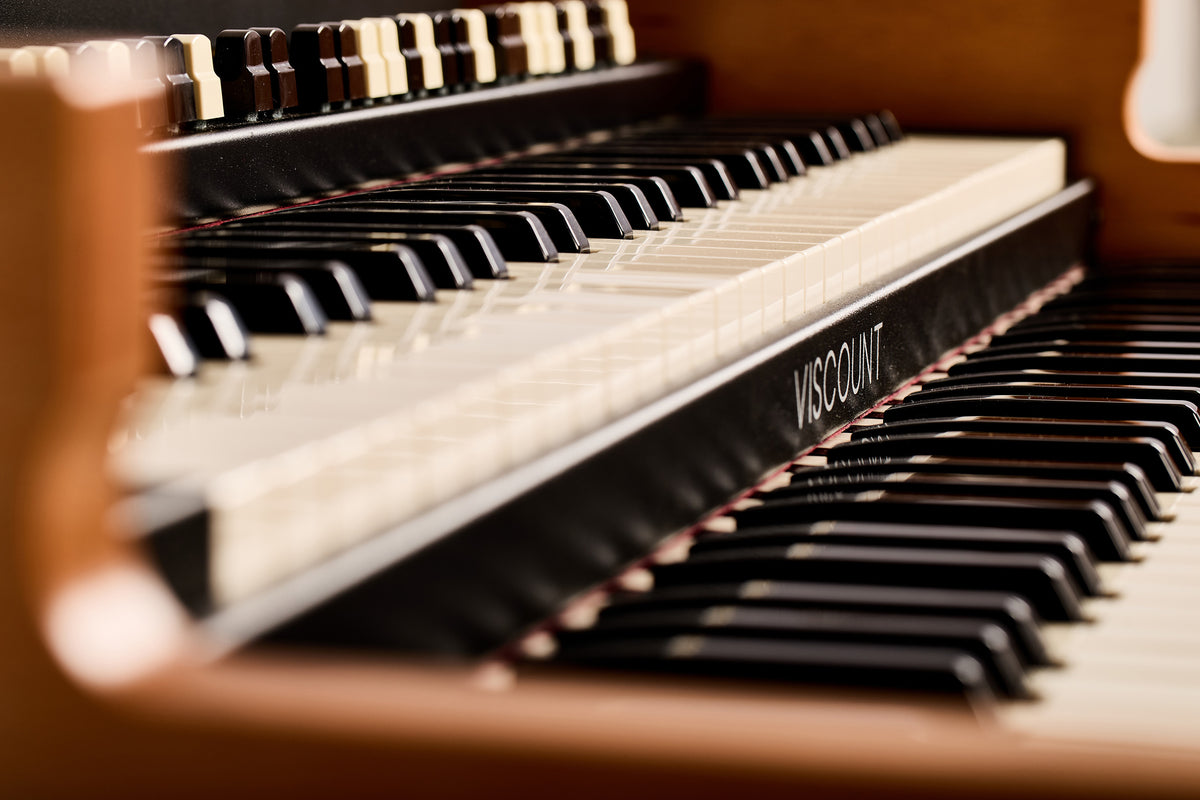 Close-up of the Viscount Legend 261 waterfall keys with the Viscount name on the keybed strip
