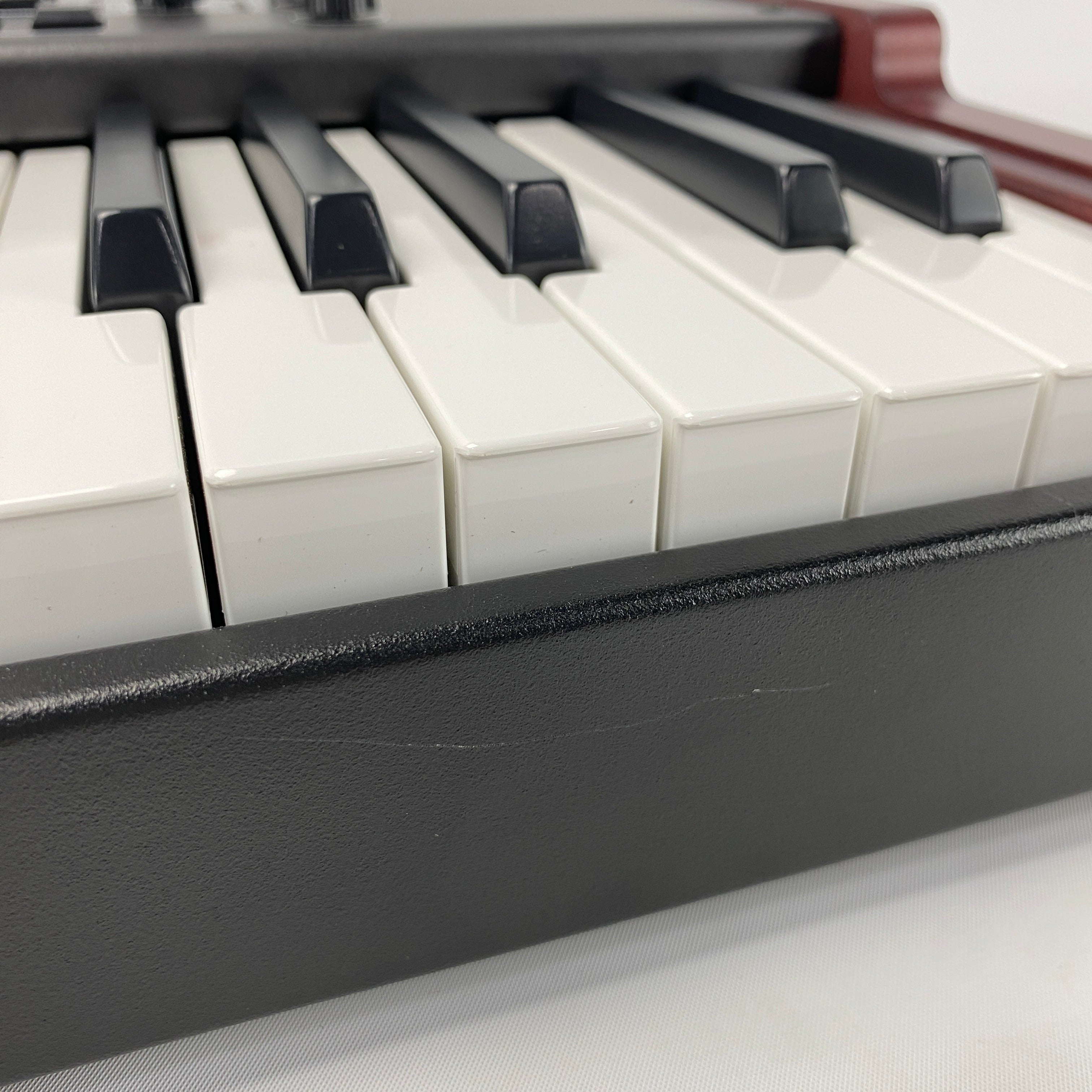 close of of the from panel of the instrument, there are some light scratches in the back metal panel below the keybed